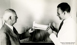 President Laughlin and Dr. Denslow examine medical instruments. Museum of Osteopathic Medicine [1984.961.30]