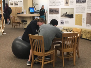 Image of student using a new stability ball in the library