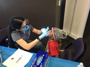 Jaiden Mercer providing dental care