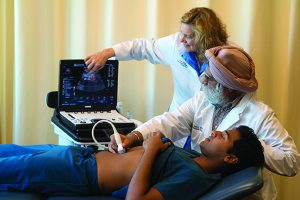 Drs. Deborah Heath and Inder Makin perform abdominal ultrasound on a student.