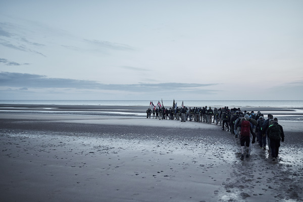 Ruck marching participants walking in a line on beach